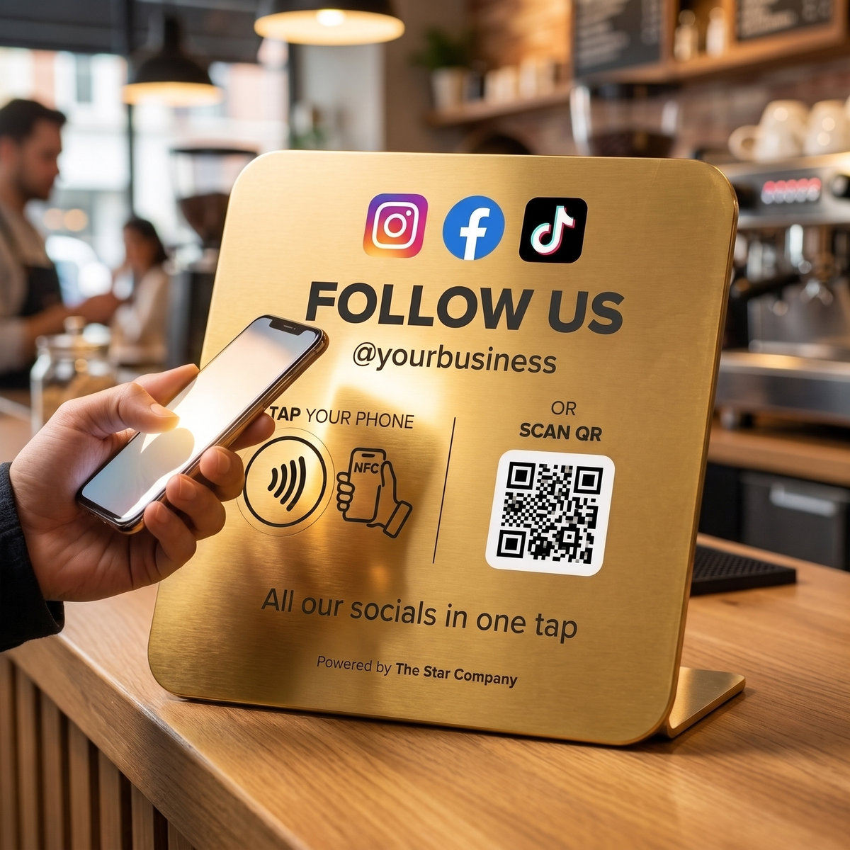 Customer tapping a phone to the 22K gold Social Media Follow Plate on a cafe counter