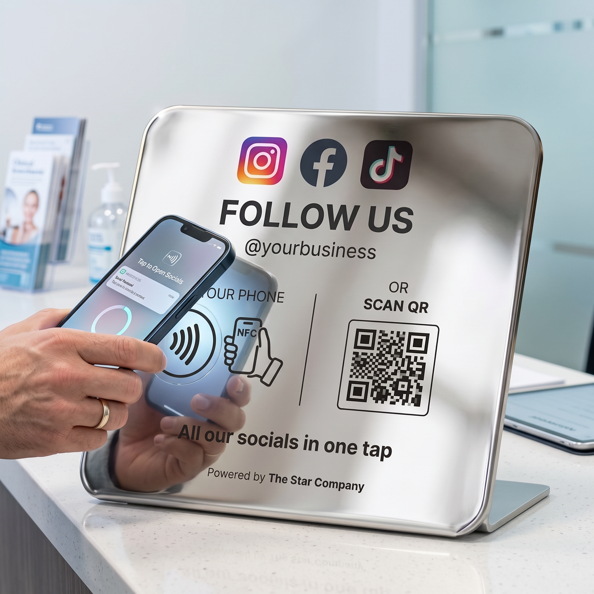 Customer tapping a phone to the stainless steel Social Media Follow Plate at a clinic reception counter