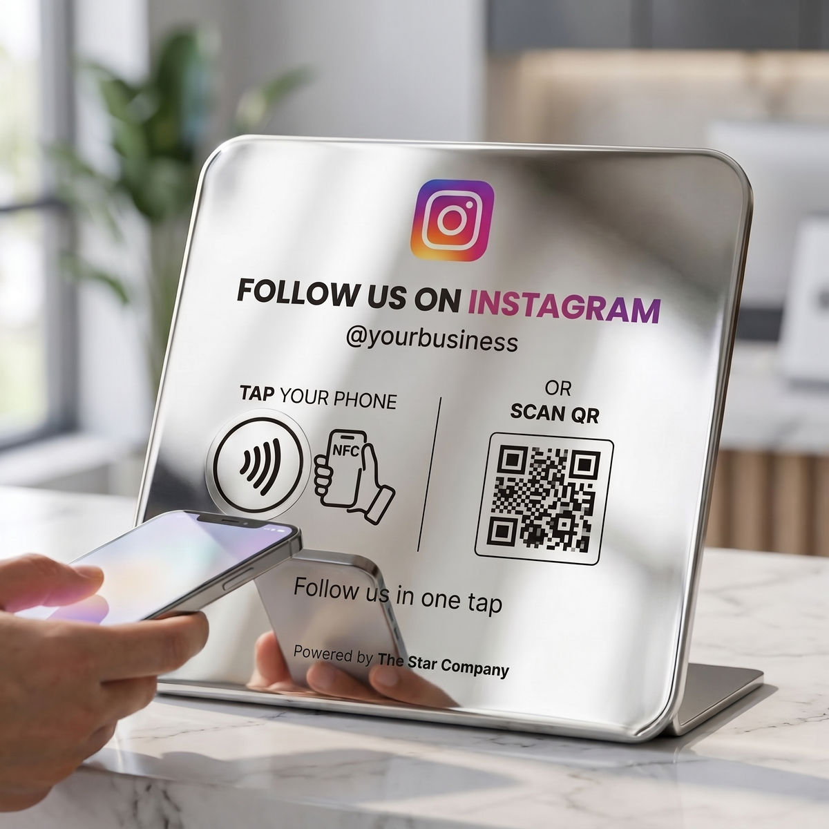 Customer tapping a phone to the stainless steel Instagram Follow Plate on a marble reception counter